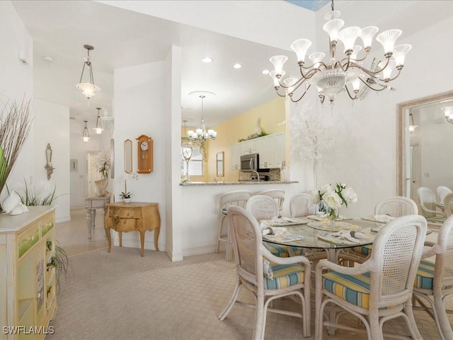 dining space featuring light carpet and an inviting chandelier