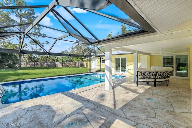 pool with an outdoor living space, fence, a yard, a patio area, and a ceiling fan