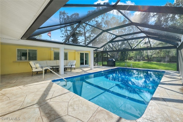 view of swimming pool with a patio, a yard, an outdoor hangout area, a lanai, and ceiling fan