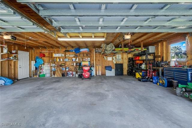 garage with a workshop area and a garage door opener