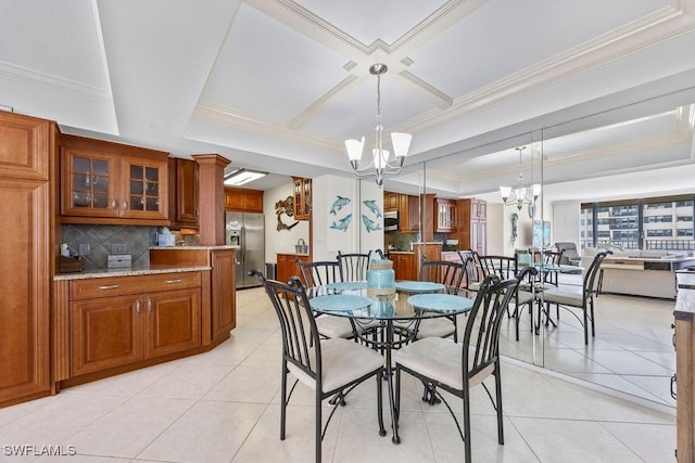 dining space with coffered ceiling, a chandelier, light tile patterned floors, a tray ceiling, and ornamental molding