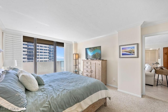 bedroom with crown molding, access to exterior, and light colored carpet