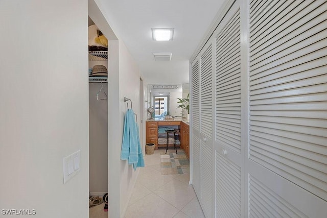 hall featuring light tile patterned floors