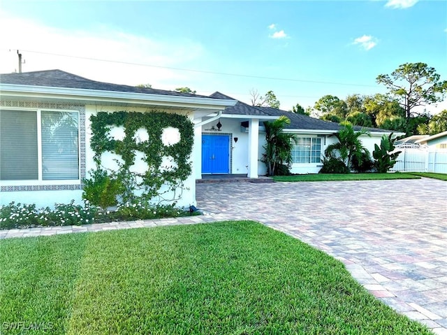 ranch-style home with a front lawn