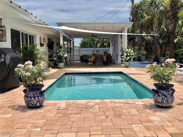 view of swimming pool featuring a patio and area for grilling