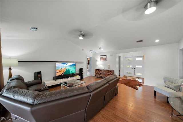 living room featuring lofted ceiling, hardwood / wood-style flooring, and ceiling fan