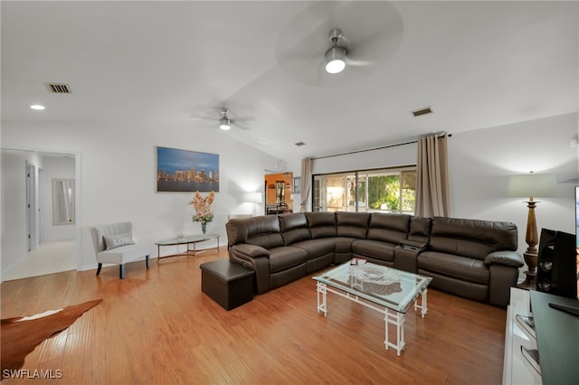 living room featuring lofted ceiling, hardwood / wood-style floors, and ceiling fan