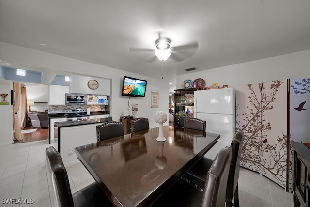 tiled dining room with ceiling fan