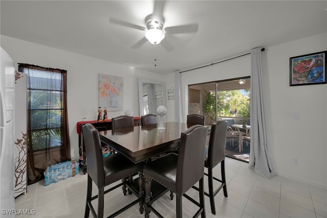 tiled dining area featuring ceiling fan