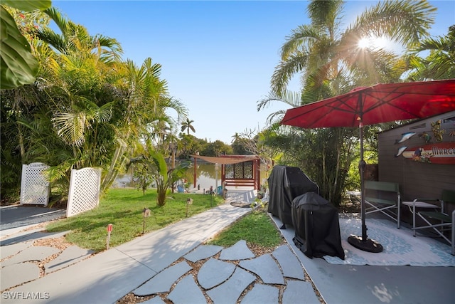 view of yard with a patio and a water view