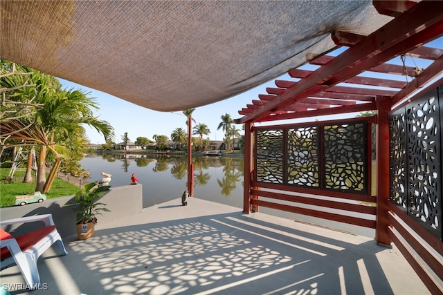 view of patio / terrace with a water view and a pergola