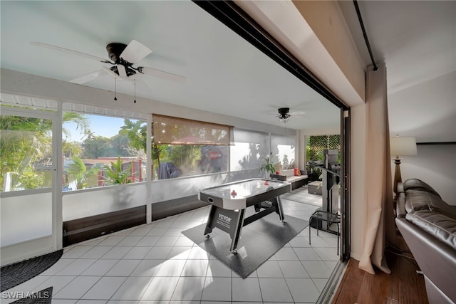 recreation room with light tile patterned flooring, a healthy amount of sunlight, and ceiling fan