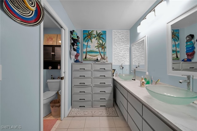 bathroom with vanity, tile patterned floors, and toilet