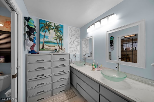 bathroom featuring vanity, tile patterned floors, and toilet