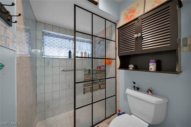 bathroom with tiled shower and toilet