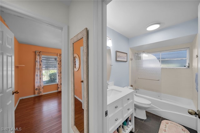 full bathroom with vanity, hardwood / wood-style floors, tub / shower combination, and toilet