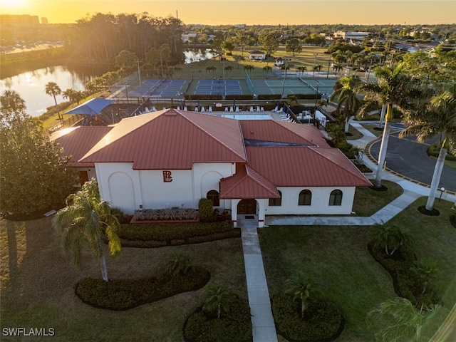 aerial view at dusk with a water view