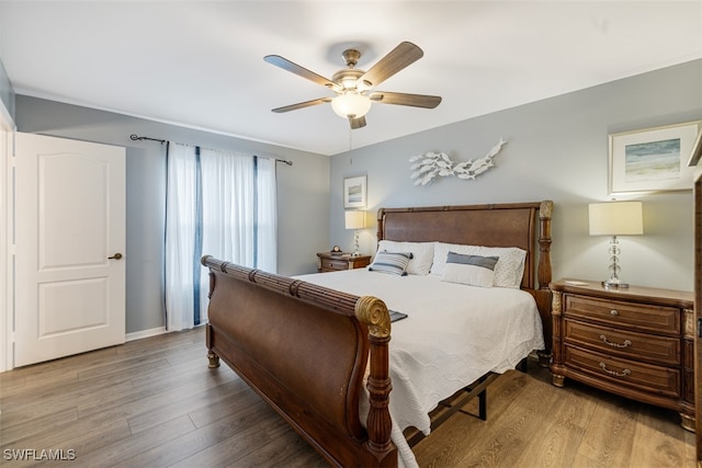 bedroom featuring a ceiling fan and wood finished floors