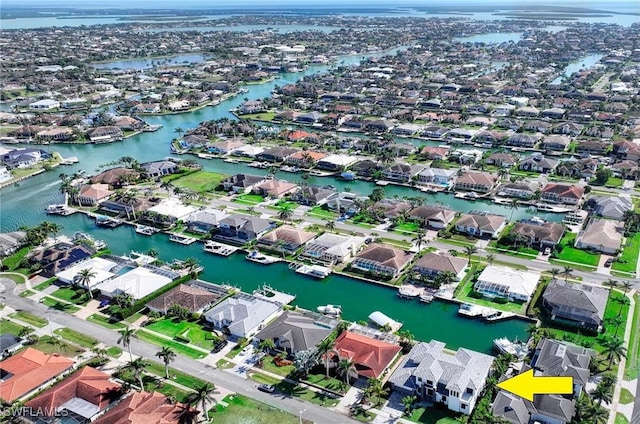 birds eye view of property featuring a water view and a residential view