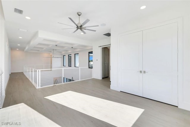 unfurnished room with light wood-type flooring, visible vents, beamed ceiling, and recessed lighting