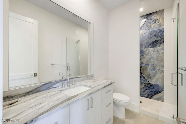 full bath featuring a shower stall, toilet, and vanity