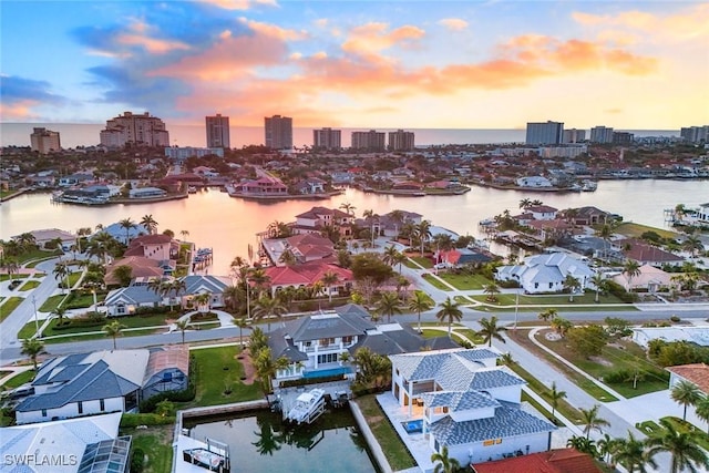 bird's eye view featuring a water view and a city view