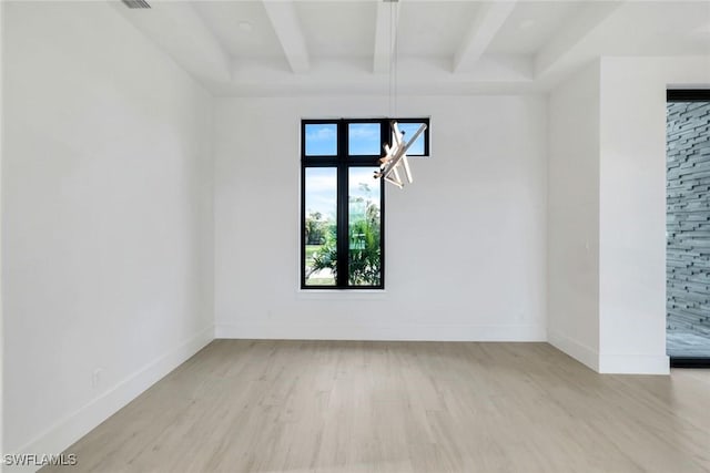 unfurnished room featuring wood finished floors, beam ceiling, and baseboards