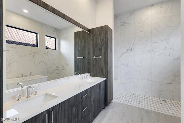 bathroom featuring double vanity, a sink, and walk in shower