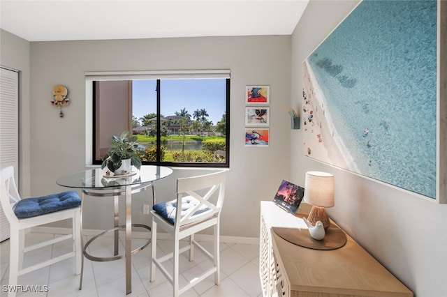 dining space with baseboards and light tile patterned floors