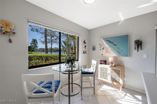 dining room featuring light tile patterned floors and baseboards