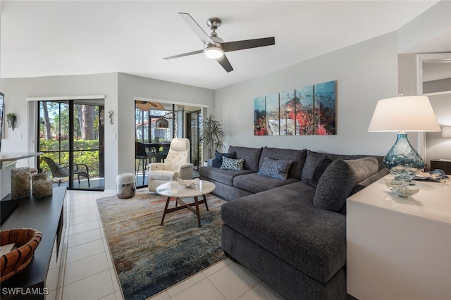 tiled living area with ceiling fan