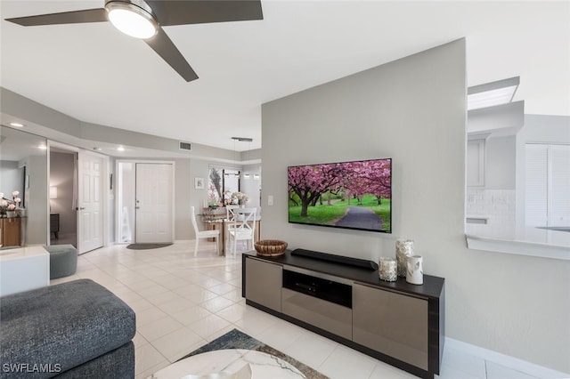 living room with visible vents, a ceiling fan, and light tile patterned flooring