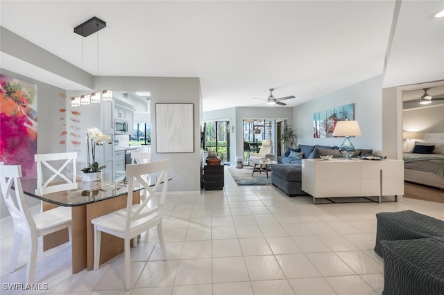 dining area with a ceiling fan and light tile patterned floors