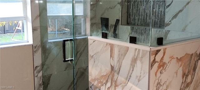 interior space featuring a marble finish shower