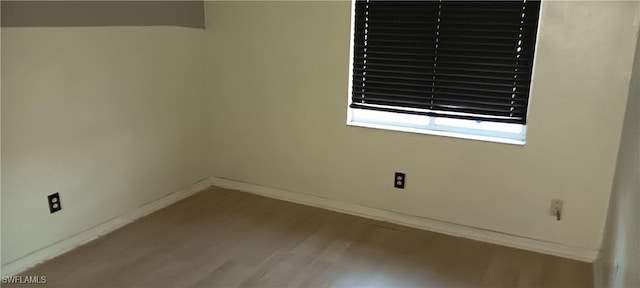 764 Chapman Ave S, Lehigh Acres, FL 33974 - unfurnished room with baseboards and wood finished floors