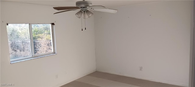 empty room with baseboards and ceiling fan