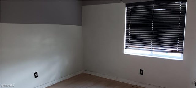764 Chapman Ave S, Lehigh Acres, FL 33974 - spare room featuring wood finished floors and baseboards