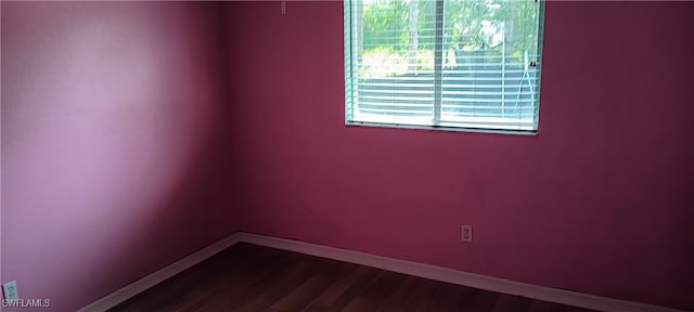 764 Chapman Ave S, Lehigh Acres, FL 33974 - empty room with baseboards and dark wood-style floors