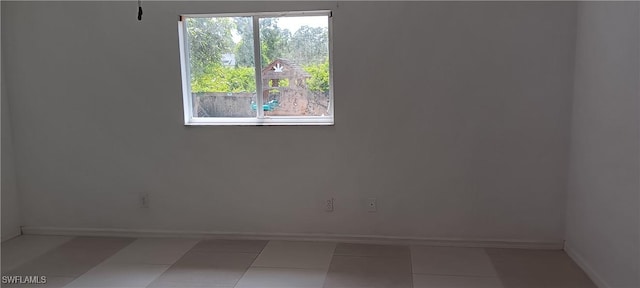 764 Chapman Ave S, Lehigh Acres, FL 33974 - spare room featuring baseboards