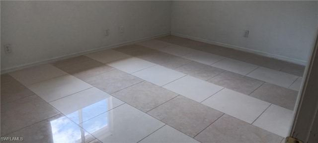 764 Chapman Ave S, Lehigh Acres, FL 33974 - empty room with baseboards and light tile patterned floors