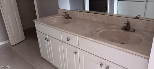 764 Chapman Ave S, Lehigh Acres, FL 33974 - full bath featuring tile patterned floors, double vanity, and a sink
