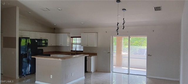 764 Chapman Ave S, Lehigh Acres, FL 33974 - kitchen featuring a center island, black appliances, a healthy amount of sunlight, and white cabinets