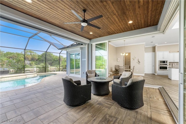 view of patio / terrace with an outdoor living space with a fire pit and glass enclosure