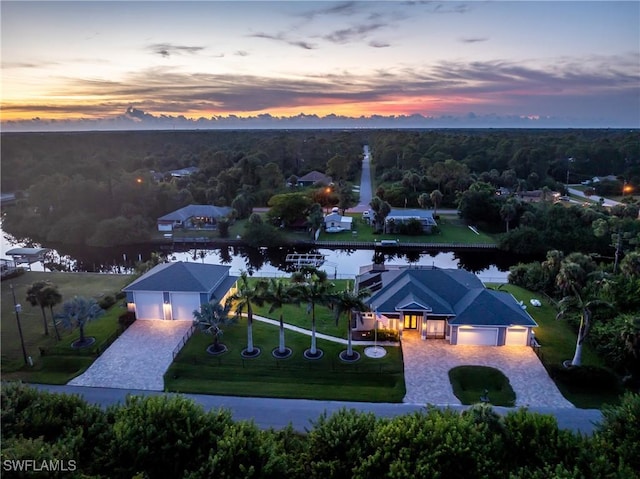 aerial view at dusk with a water view