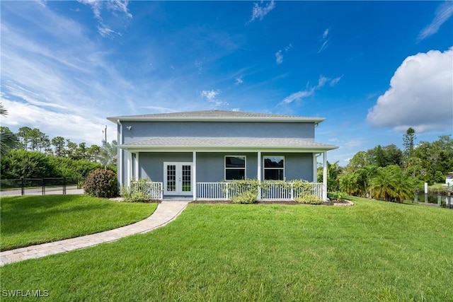 rear view of house with a yard and french doors