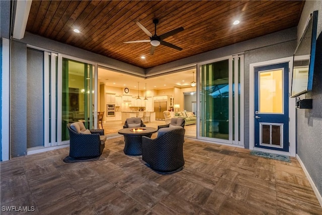 view of patio with ceiling fan and a fire pit