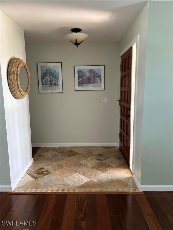 hall with hardwood / wood-style flooring