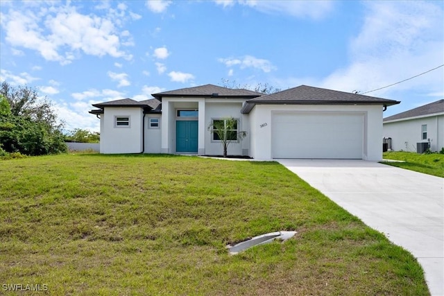 view of front of property featuring a garage, cooling unit, and a front lawn