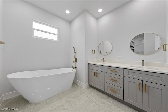 bathroom featuring vanity and a bath