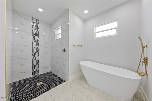 bathroom with independent shower and bath and a healthy amount of sunlight